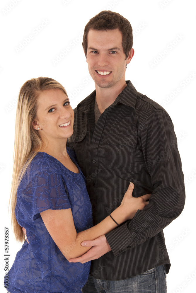 Happy young couple embraced looking at camera Happy young couple embraced looking at camera