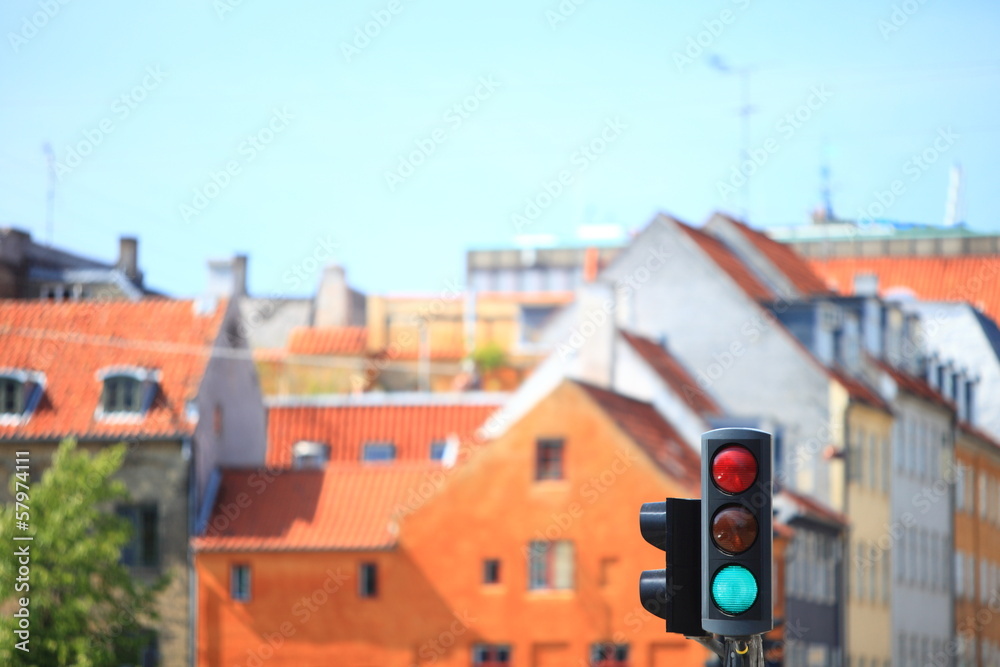 Traffic lights against city background