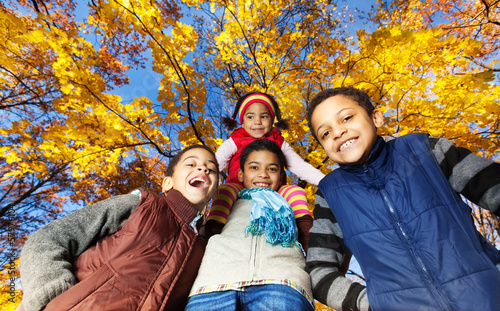 Four boys in autumn park photo