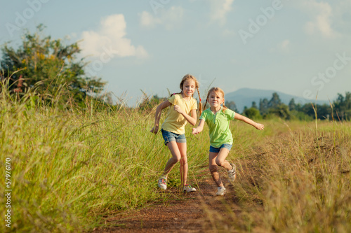 two girls running on the road