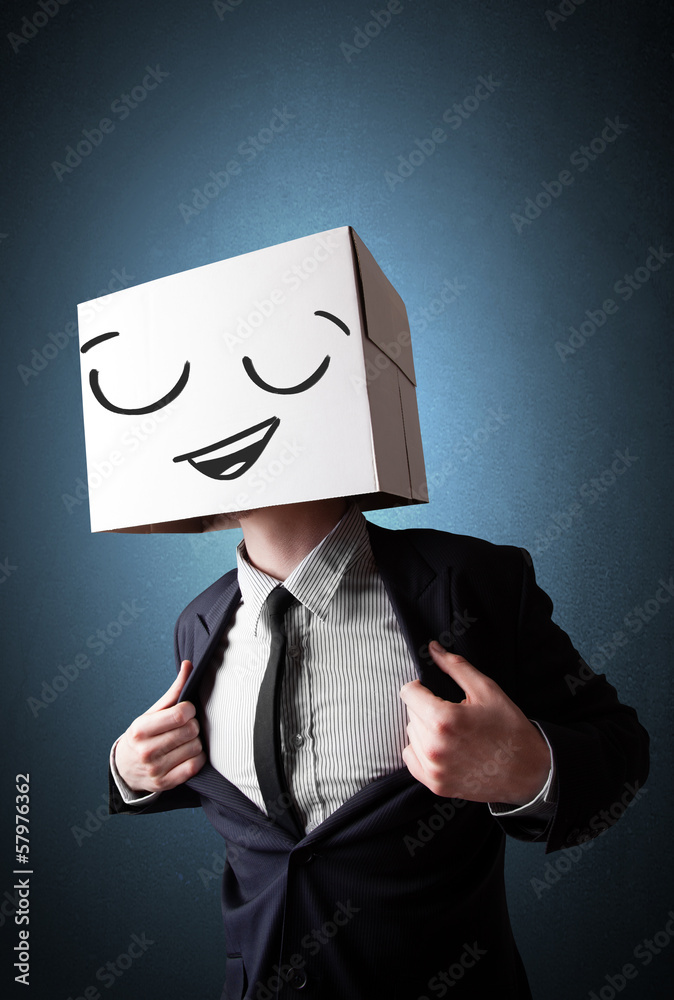 Businessman gesturing with a cardboard box on his head with smil Businessman gesturing with a cardboard box on his head with smil