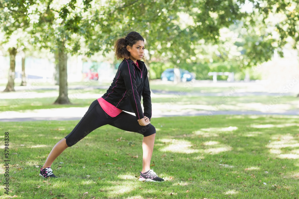 Healthy woman doing stretching exercise in park Healthy woman doing stretching exercise in park