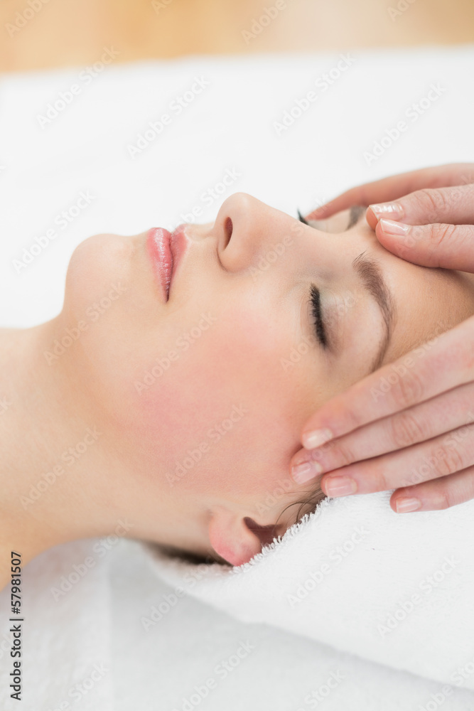 Hands massaging a beautiful woman's forehead