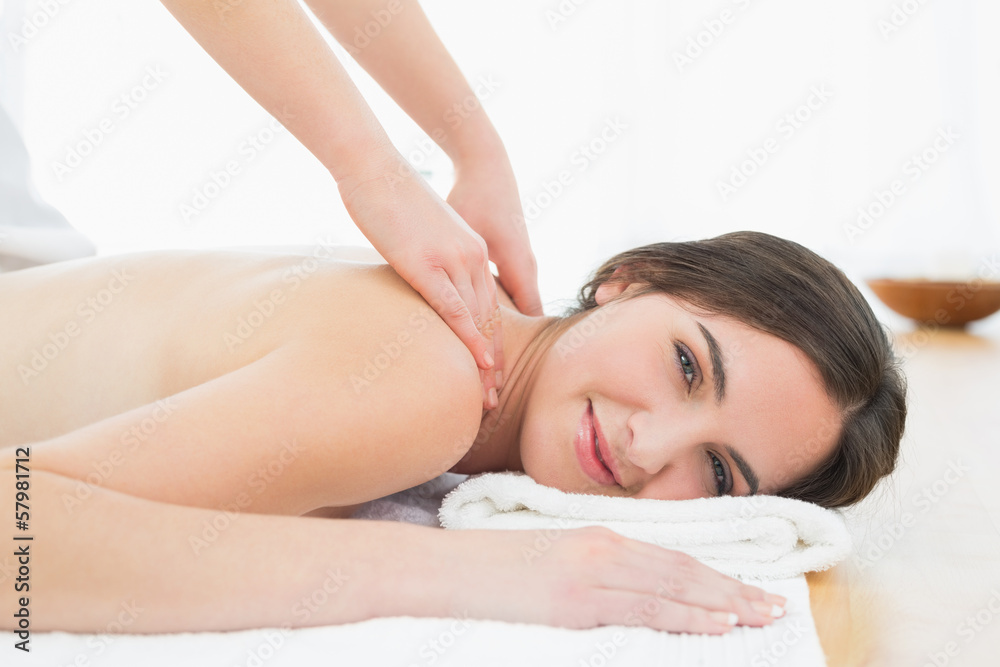 Smiling woman enjoying shoulder massage at beauty spa Smiling woman enjoying shoulder massage at beauty spa