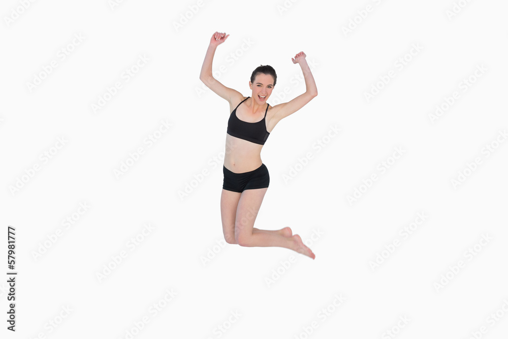 Full length of a sporty young woman jumping