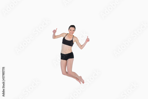 Full length of a sporty young woman jumping