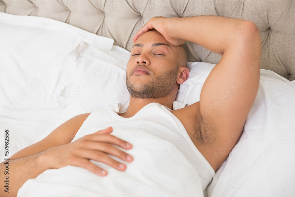 Young man sleeping in bed