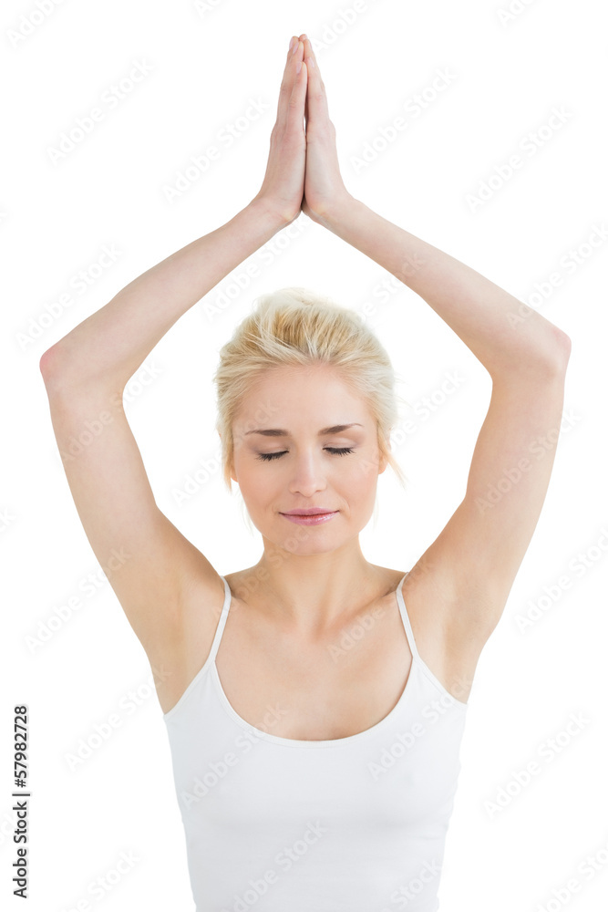 Toned woman with joined hands and eyes closed Toned woman with joined hands and eyes closed