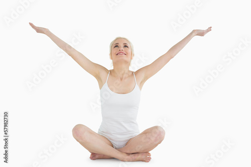 Toned young woman sitting with arms outstretched © lightwavemedia