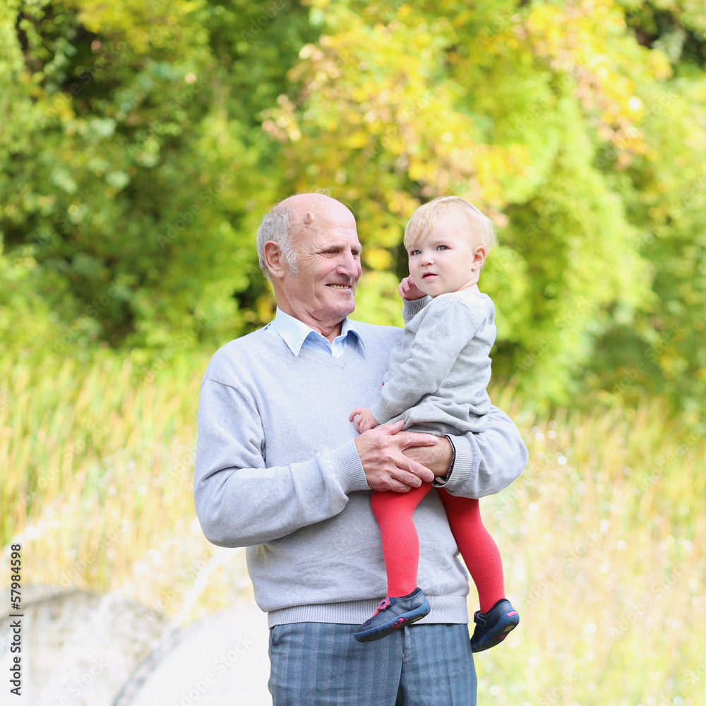 Happy grandfather with baby granddaughter in beautiful park Happy grandfather with baby granddaughter in beautiful park
