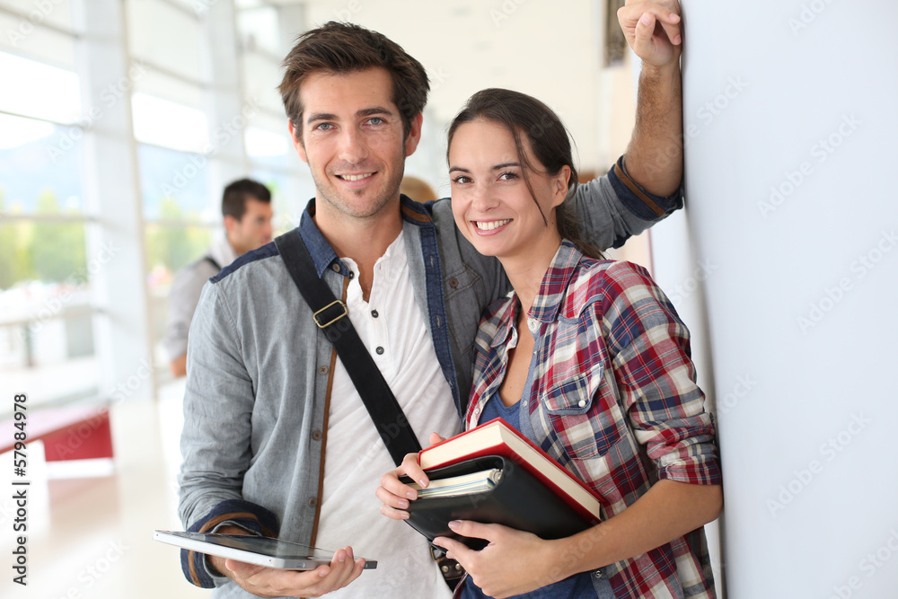 Fototapeta premium Friends standing in university hallway