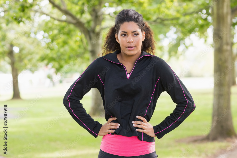 Tired healthy young woman standing in the park Tired healthy young woman standing in the park