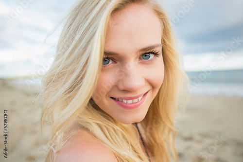 Close up portrait of smiling relaxed blond at beach © WavebreakMediaMicro