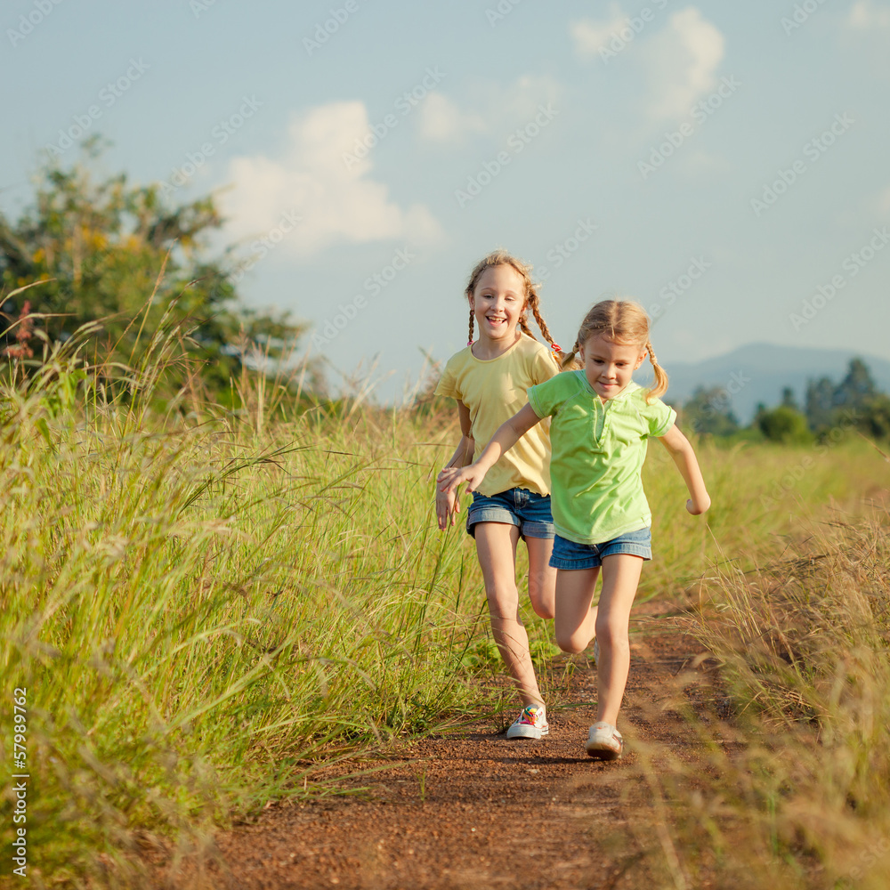 Fototapeta premium two girls running on the road
