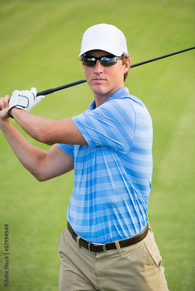 Athletic young man playing golf Athletic young man playing golf