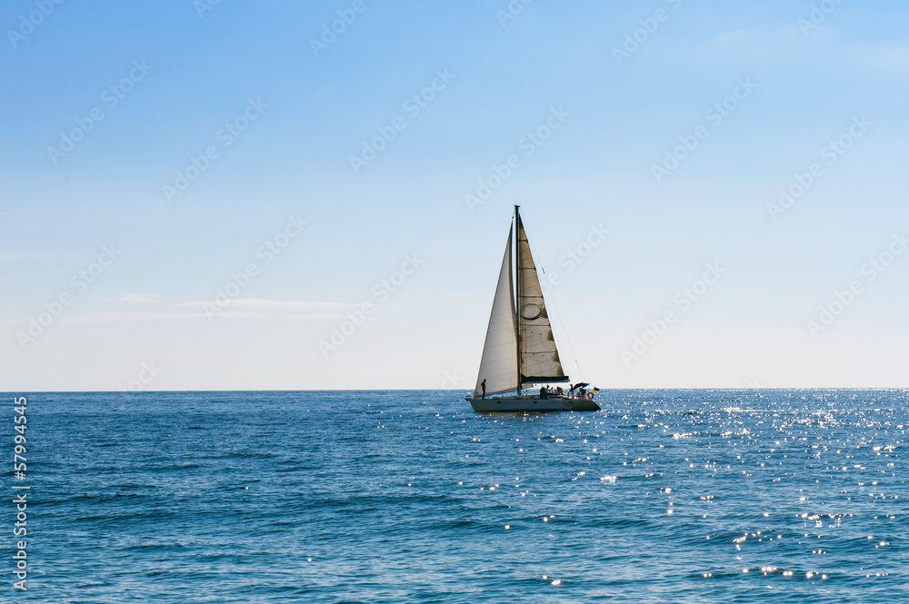 Small sailing boat in blue and calm sea