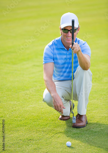 Athletic young man playing golf