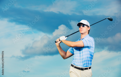 Golfer swinging golf club
