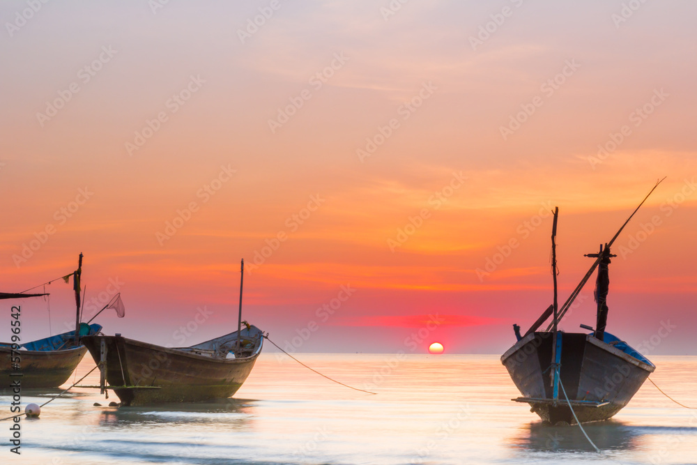 boats in the sea under sunset