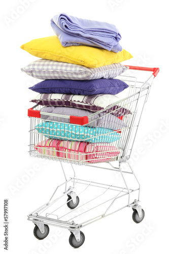 Shopping cart with pillows and plaids, isolated on white © Africa Studio