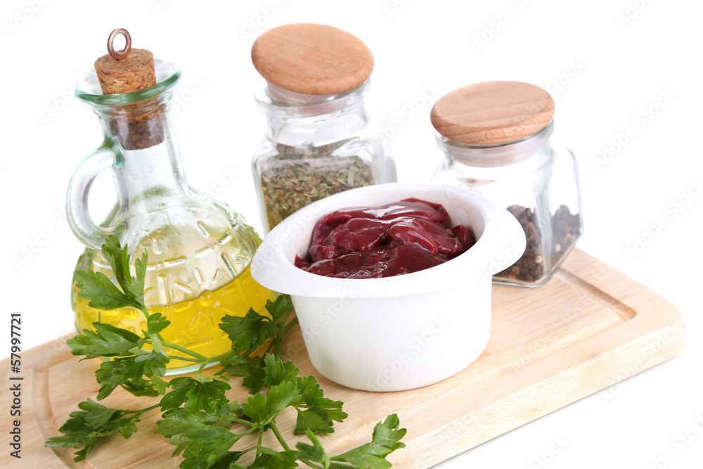 Raw liver in bowl with spices and condiments isolated on white Raw liver in bowl with spices and condiments isolated on white