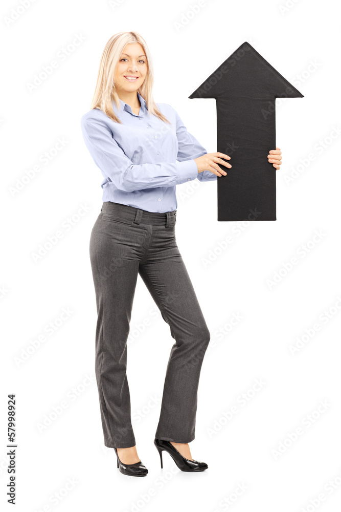 Full length portrait of a blond smiling woman holding am arrow Full length portrait of a blond smiling woman holding am arrow