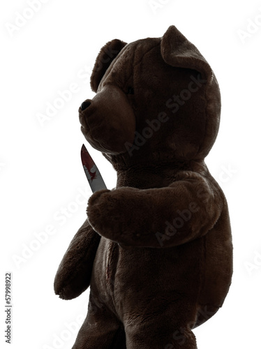 strange killer teddy bear holding bloody knife  silhouette