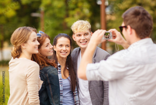 teenagers taking photo outside