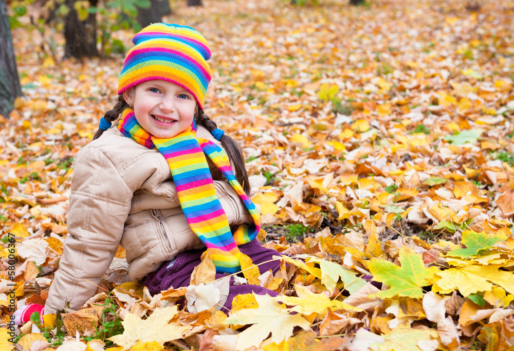 girl sit on yellow leaves in autumn park girl sit on yellow leaves in autumn park