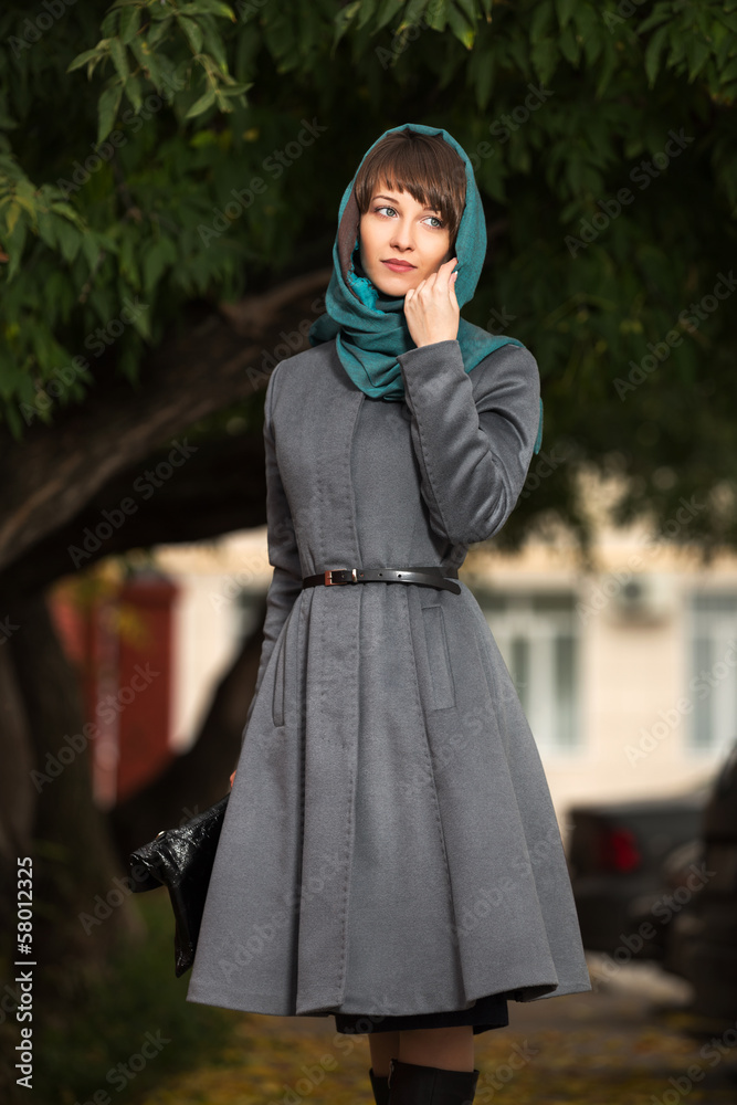 Young woman in grey classic coat with a handbag Young woman in grey classic coat with a handbag