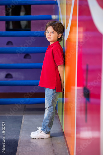 Unhappy Boy Standing Against Wall