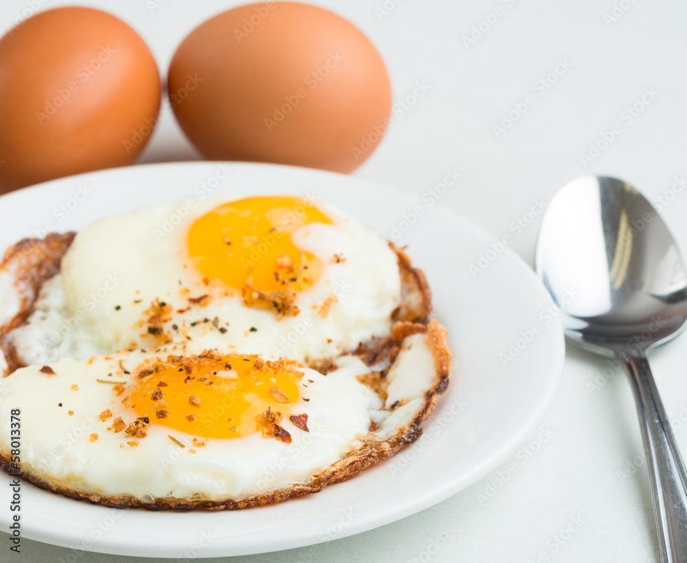 Fried eggs. Simple, delicious, healthy meal on white background Fried eggs. Simple, delicious, healthy meal on white background