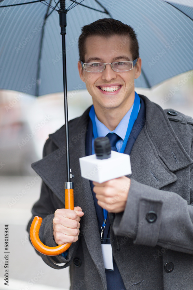 young journalist working outdoors in the rain young journalist working outdoors in the rain