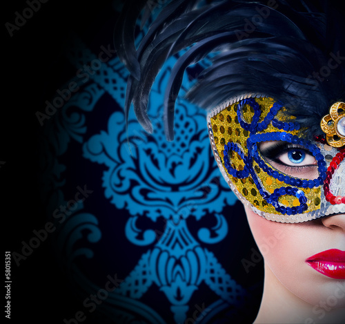 Beautiful girl in carnival mask with red lips