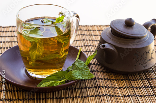 Green tea and leaves of mint in a glass cup