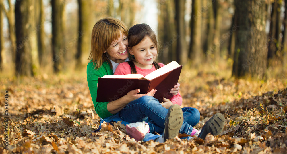 Mother is reading book with her daughter Mother is reading book with her daughter