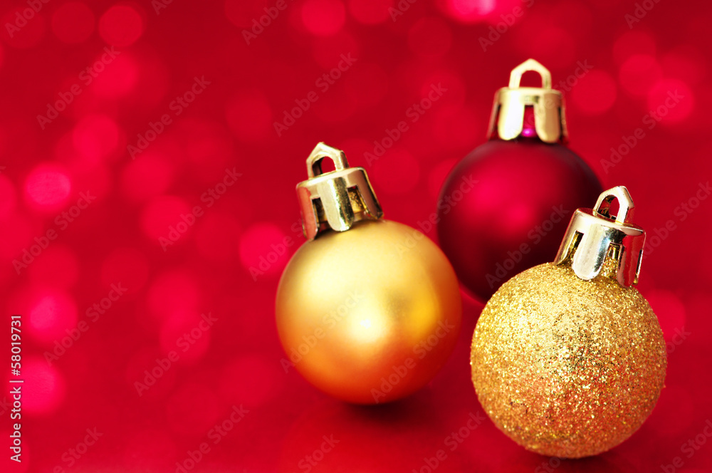Small Christmas balls on red sparkle background. Small Christmas balls on red sparkle background.