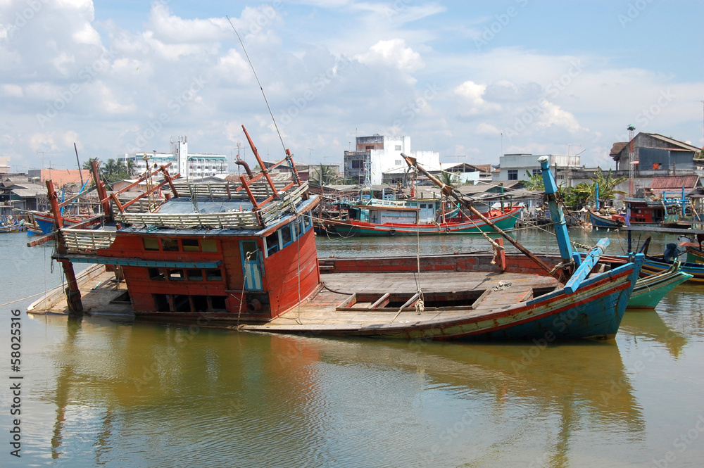 Abandoned drowned timber ship at port