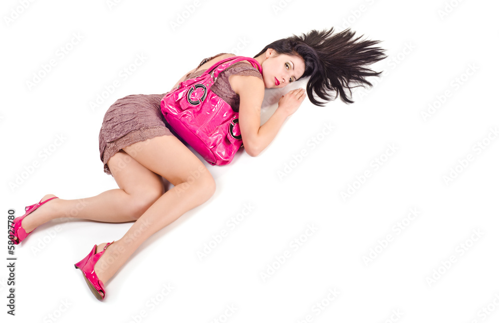 Woman lying with disheveled hair and holds on shoulder bag Woman lying with disheveled hair and holds on shoulder bag