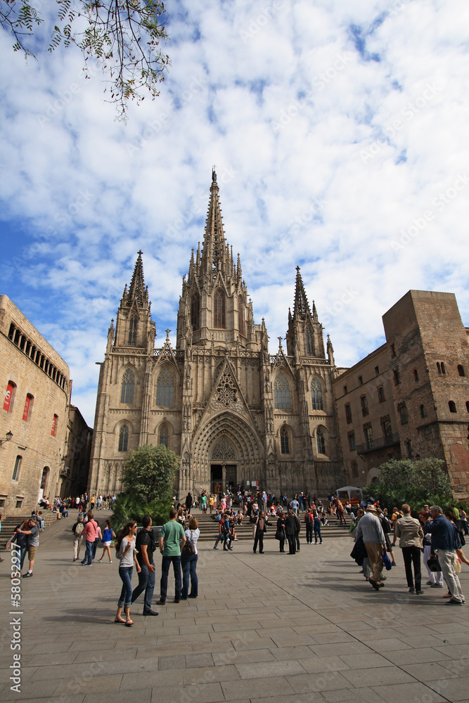 Tourists look at Barcelona cathedral facade