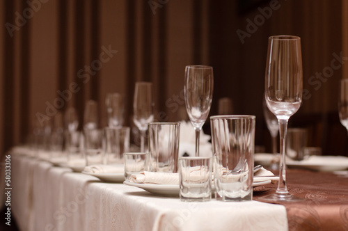 Restaurant table layout with row og wineglasses photo