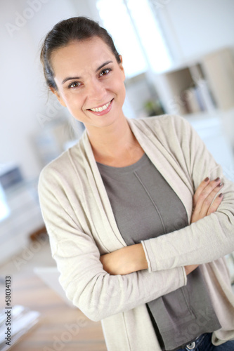 Portrait of smiling working woman in office Free Download Portrait of smiling working woman in office - GFXLoad