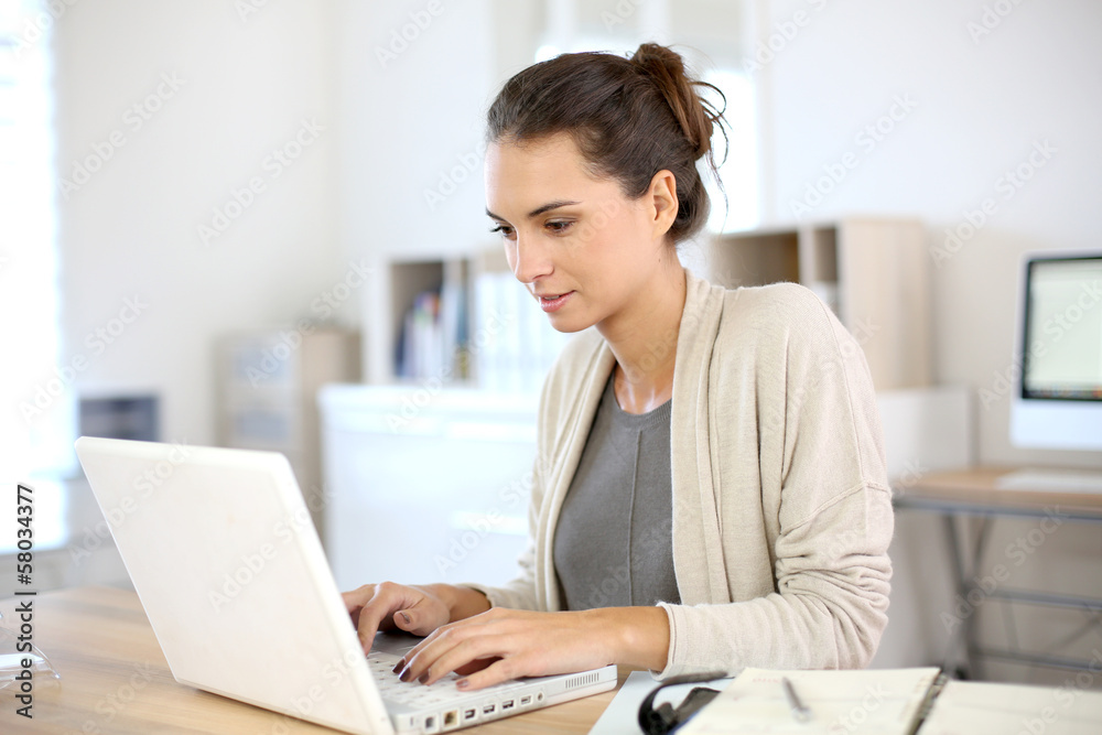Attractive woman working in office on laptop Attractive woman working in office on laptop