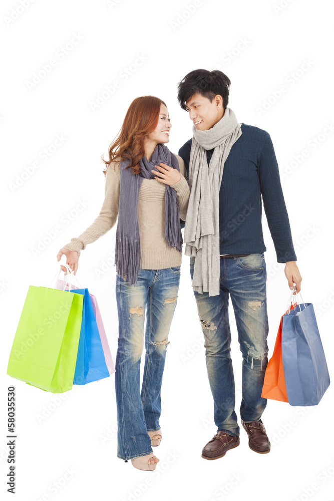 Happy couple doing shopping isolated on white Happy couple doing shopping isolated on white