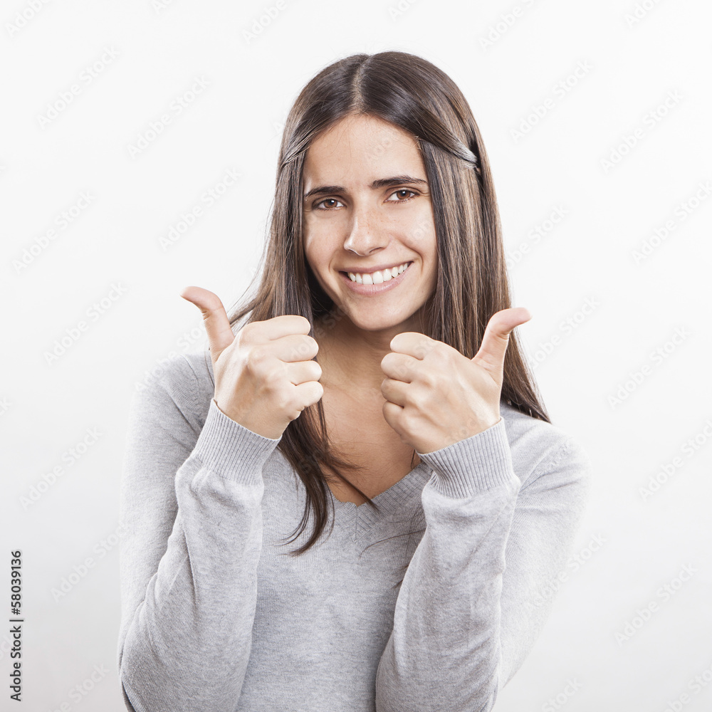 Happy smiling girl with thumbs up gesture, isolated on white bac Happy smiling girl with thumbs up gesture, isolated on white bac