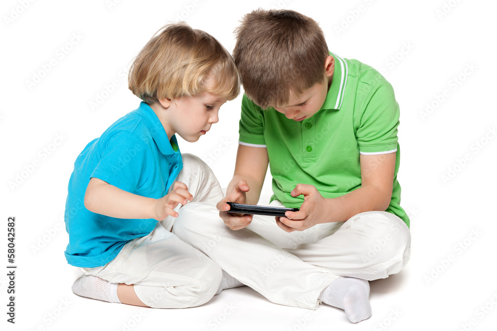 Brothers plaing with a new gadget Brothers plaing with a new gadget