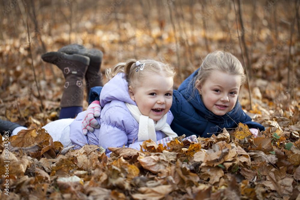 Two sisters in autumn park Two sisters in autumn park