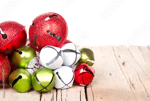 Christmas jingle bells on a  plank photo