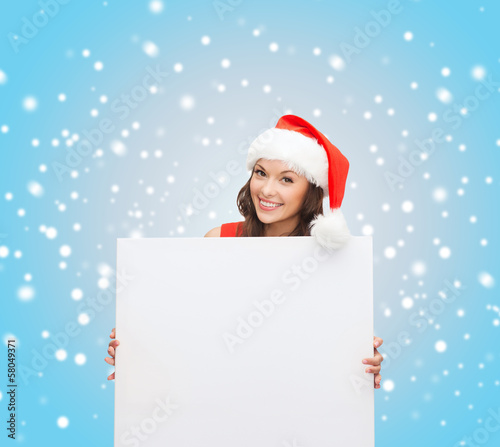 woman in santa helper hat with blank white board © Syda Productions
