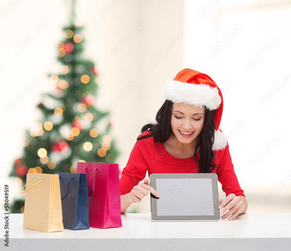 smiling woman in santa helper hat with tablet pc smiling woman in santa helper hat with tablet pc